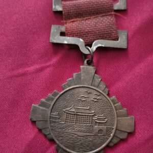 A 1936 Xi'an Incident commemorative medal with a red ribbon.