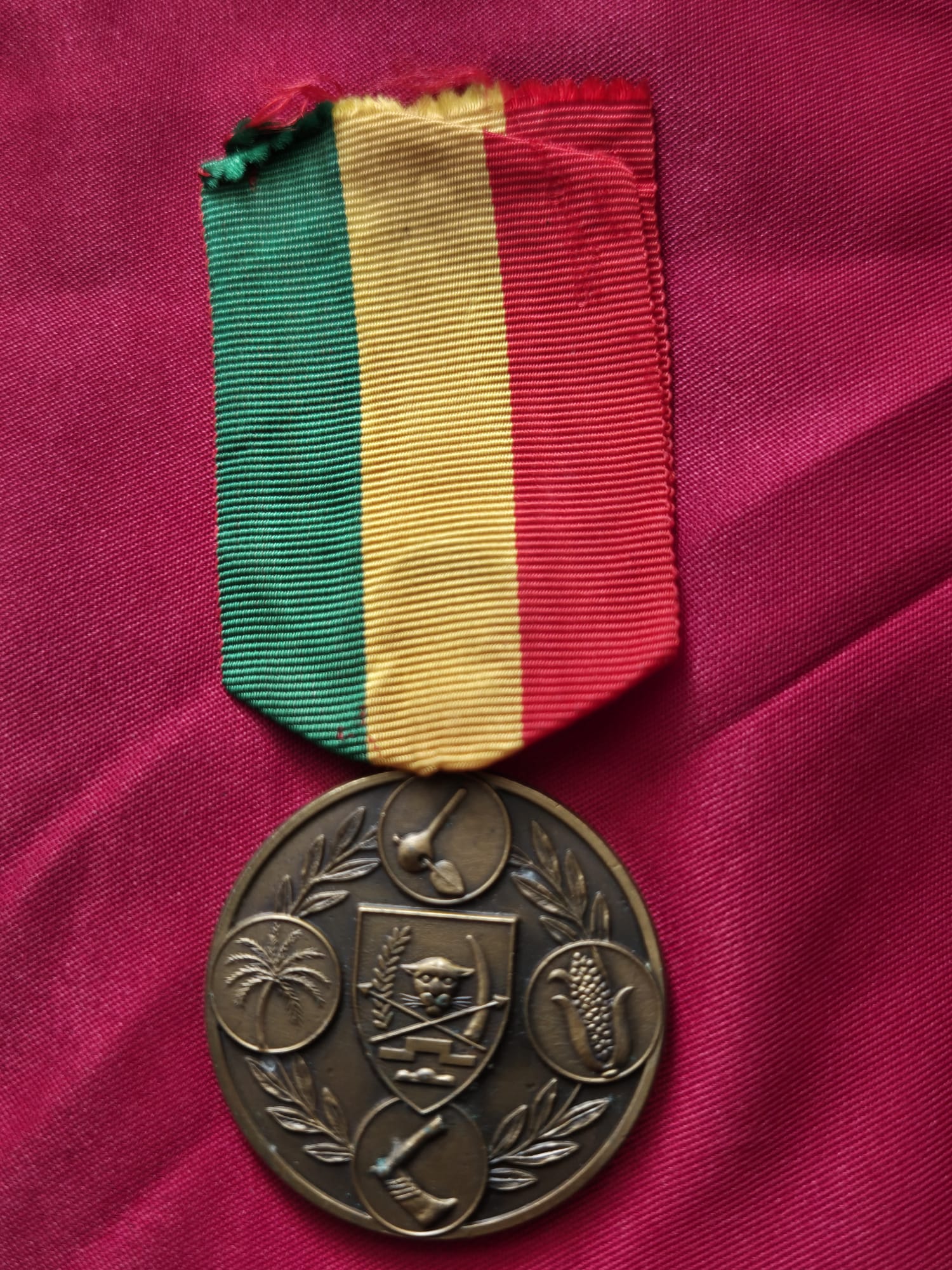 Republic of Zaire Medal for Agricultural Merit with a green, yellow, and red ribbon.