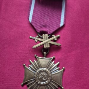A Polish III RP Cross of Merit with crossed swords.