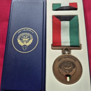 Boxed Kuwait Liberation Medal from 1991 with miniature ribbon.