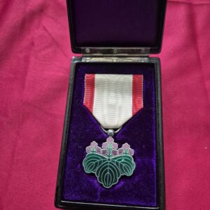 Japanese Order of the Rising Sun medal with paulownia crest in case.