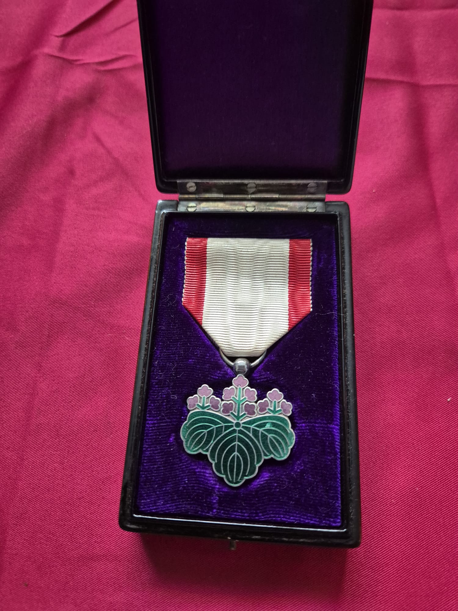 Japanese Order of the Rising Sun medal with paulownia crest in case.